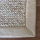 Tapis de salon sur mesure beige clair effet laine bouclée finition gansée